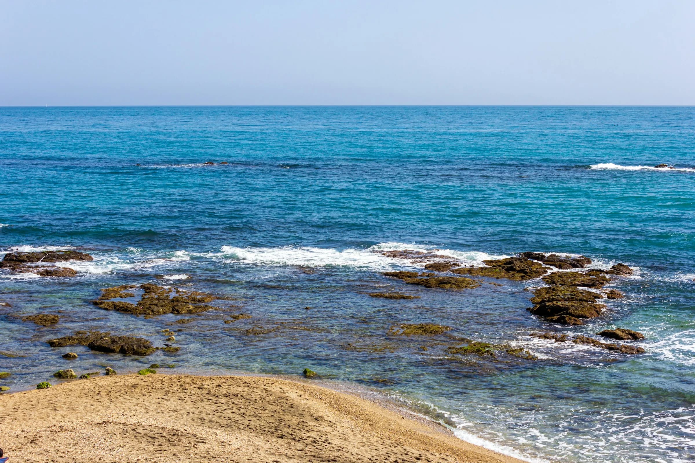 Waves breaking on the rocky shore at Benalmádena
